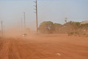Dust plume on dirt road