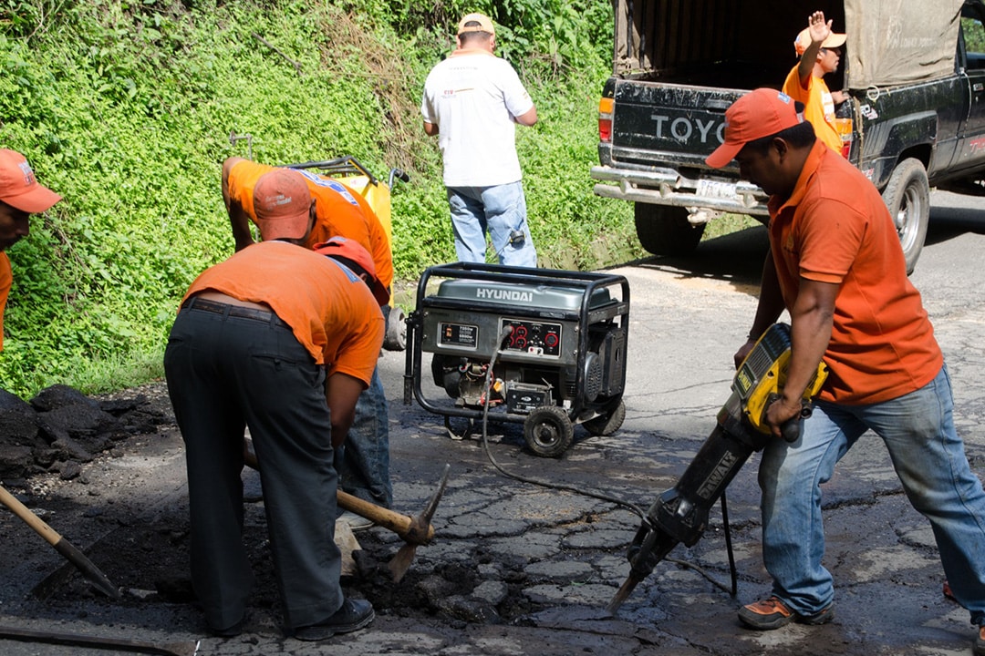 Workman repairing potholes