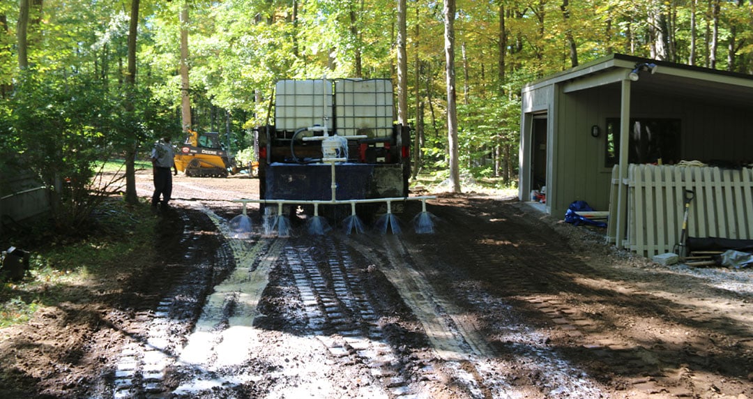 Water truck creating an access road for firefighting vehicles past equipment hut using RoadMaster