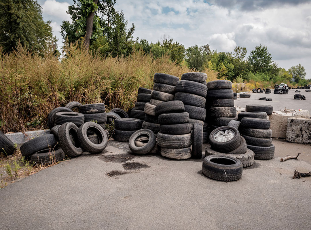 dumped old tires on road edge