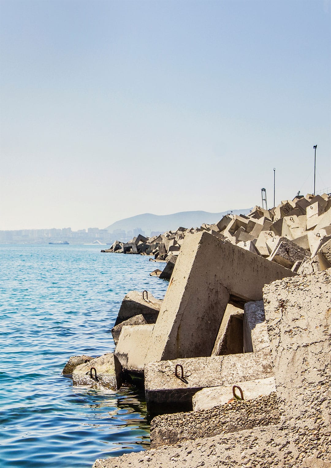 concrete blocks on the shore of a body of water