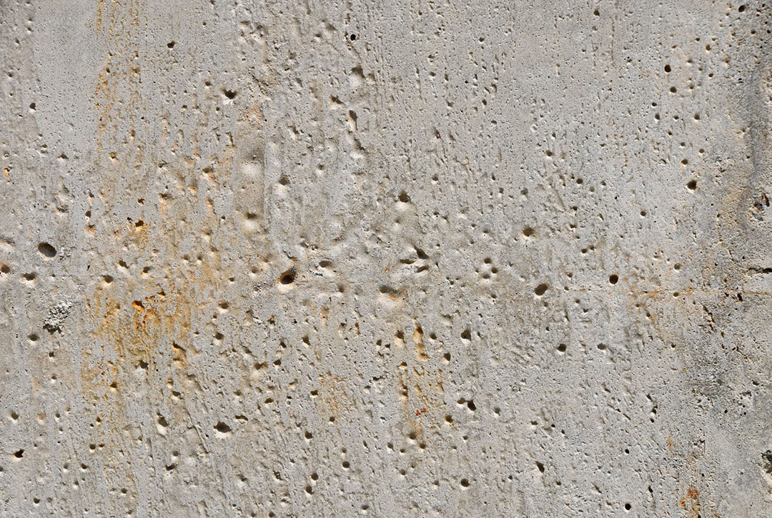 A close-up of an old porous concrete wall