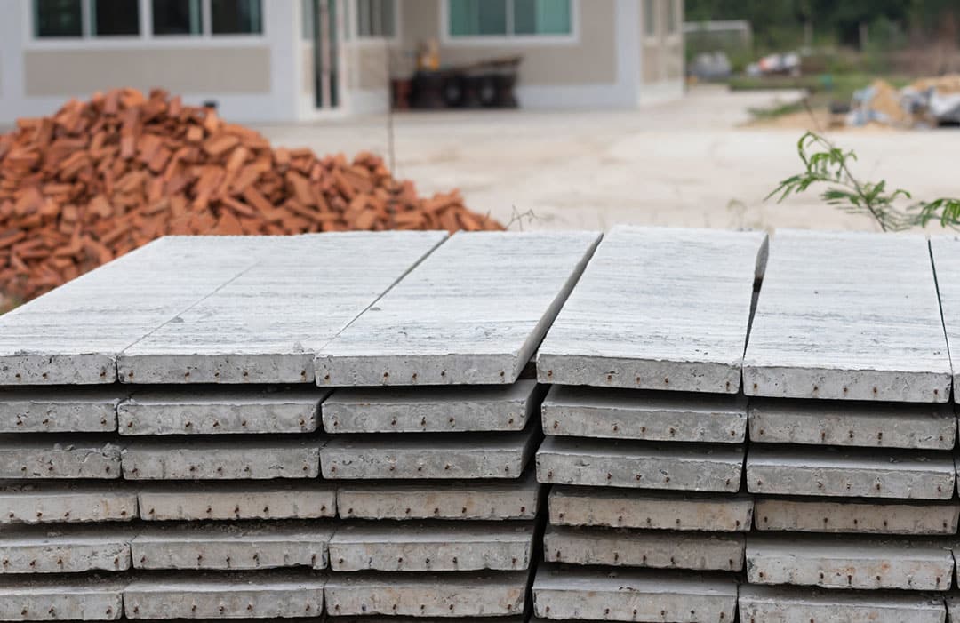 a stack of pre-cast concrete planks at a building site