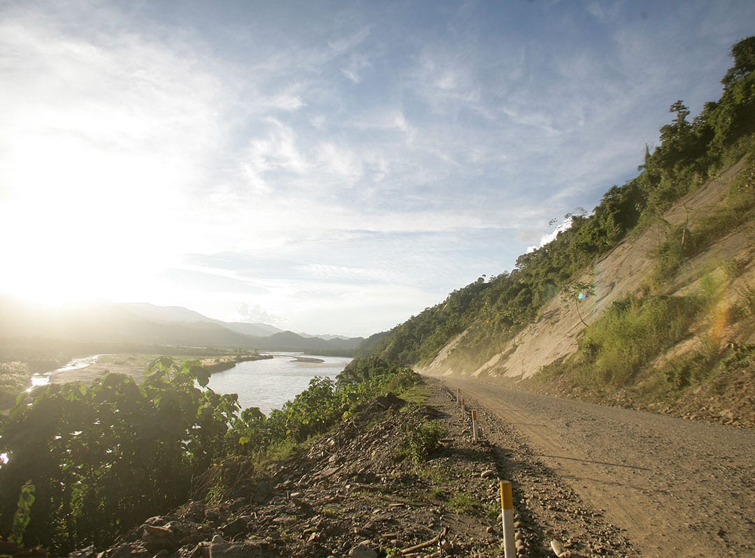 mining road on mountain side near a river for AggreBind Peru project