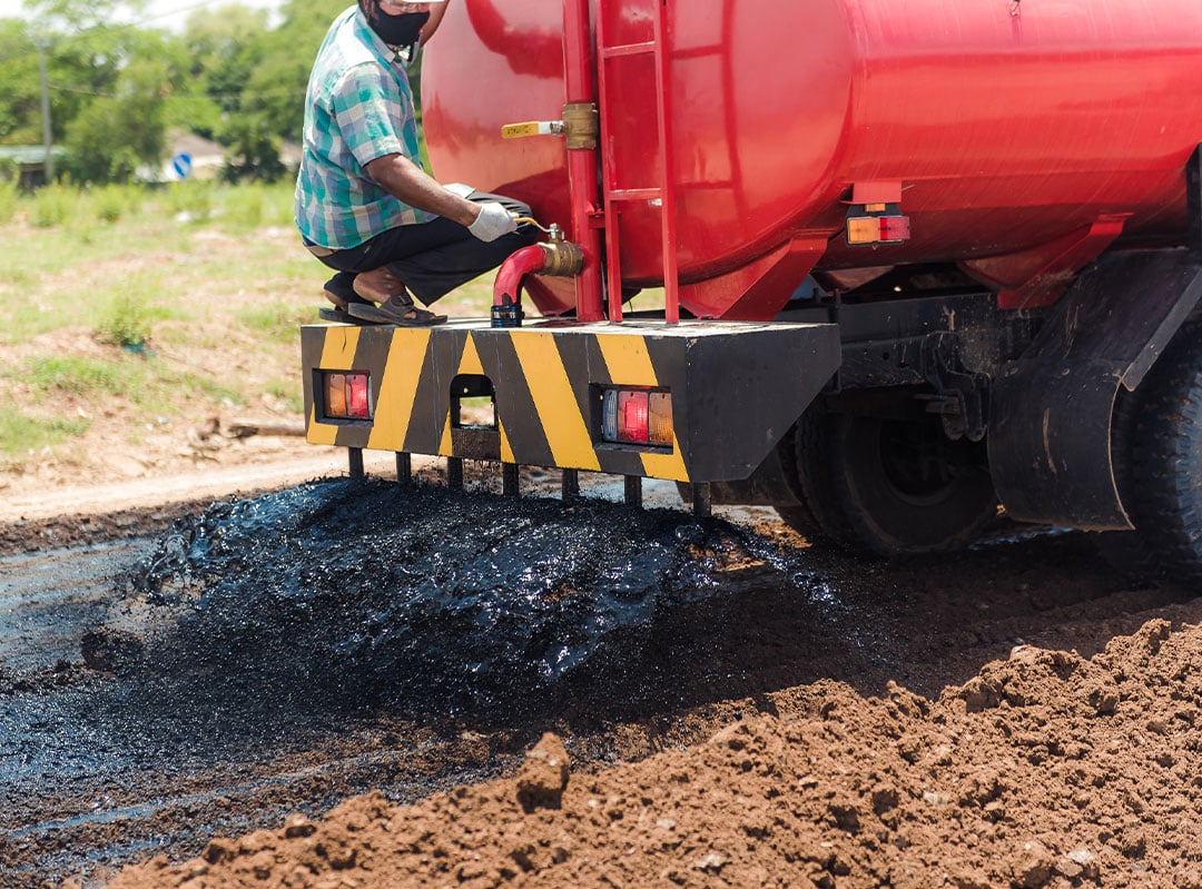 AggreBind HiPower Seal Black copolymer being dispersed from a water-truck onto a road under construction